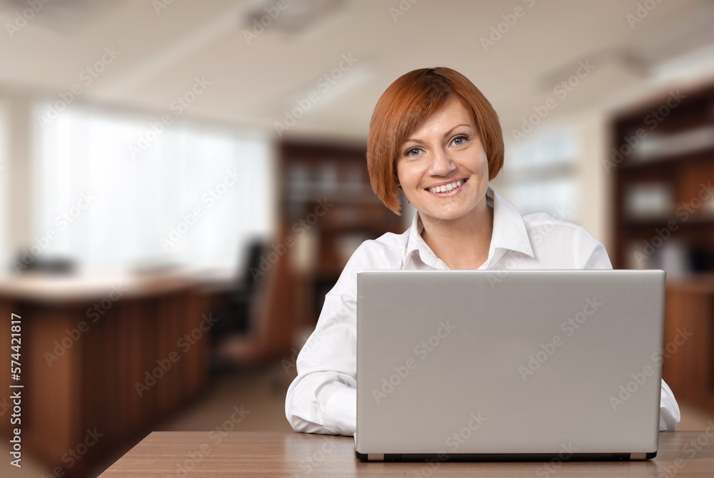 Young business woman at work with laptop. Young business woman at work with laptop.