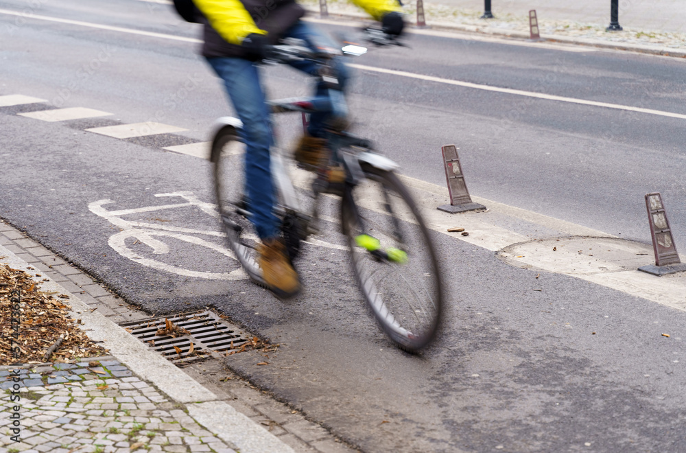 Naklejka premium The cyclist travels on a bicycle path.