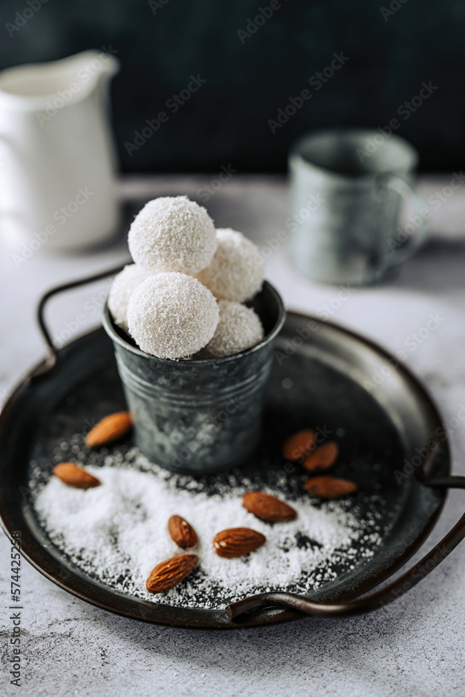 Beautiful and delicious homemade coconut flakes truffles with almonds and nuts in a retro grunge style. Beautiful and delicious homemade coconut flakes truffles with almonds and nuts in a retro grunge style.