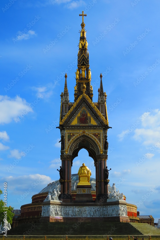 Fototapeta premium Albert Memorial in London with Royal Albert Hall behind and blue sky in summer