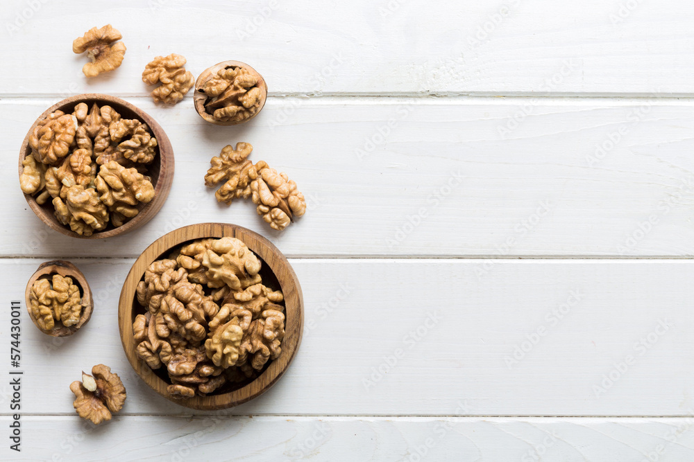 Fresh healthy walnuts in bowl on colored table background. Top view Healthy eating bertholletia concept. Super foods Fresh healthy walnuts in bowl on colored table background. Top view Healthy eating bertholletia concept. Super foods