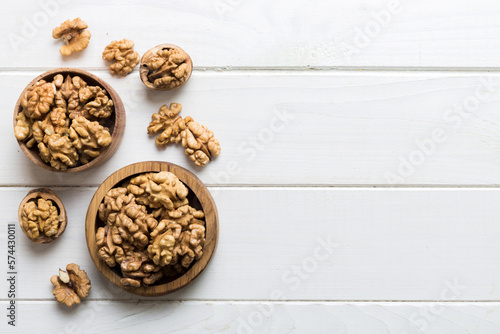 Fresh healthy walnuts in bowl on colored table background. Top view Healthy eating bertholletia concept. Super foods