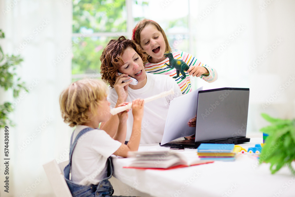 Mother working from home with kids. Mother working from home with kids.