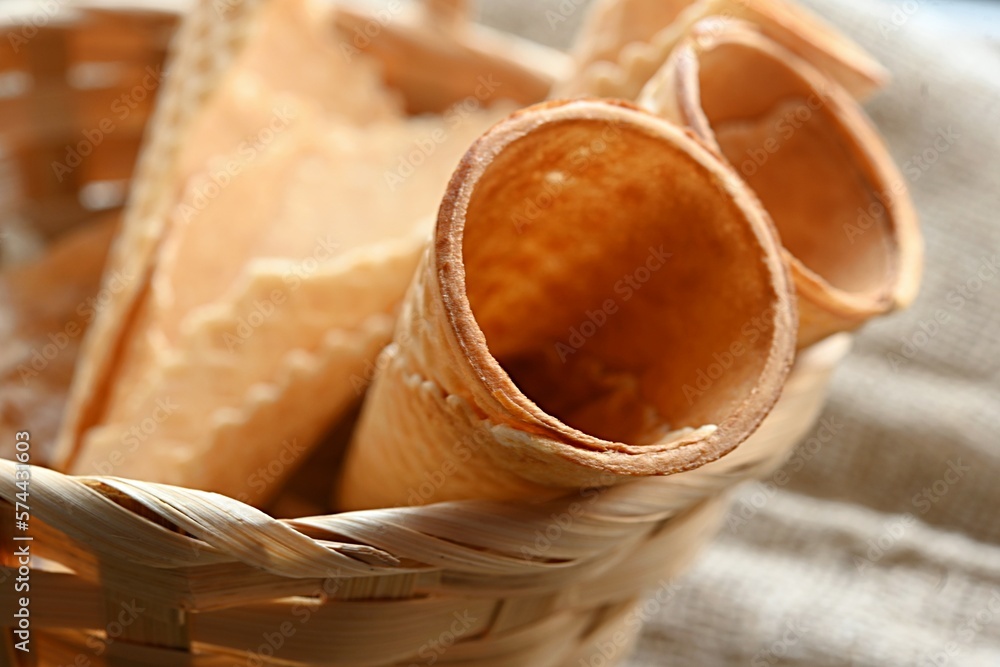 Obraz premium empty waffle cone for ice cream in a basket. place for text. copy space. dessert