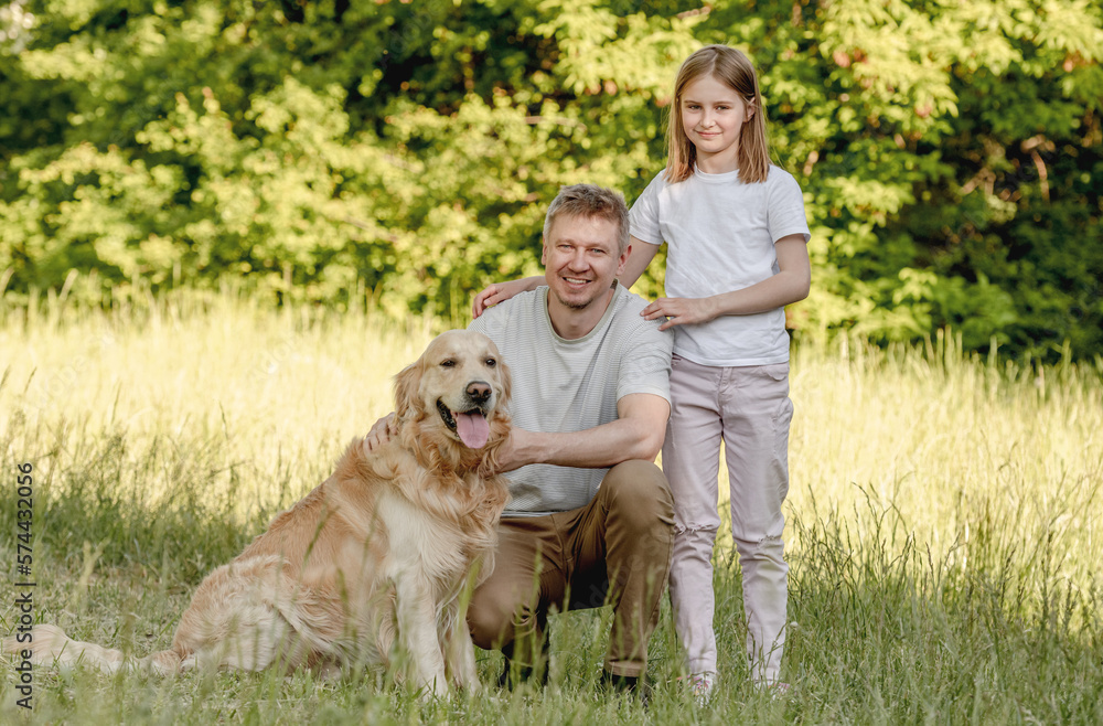 Dad and his daugter play with dog Dad and his daugter play with dog