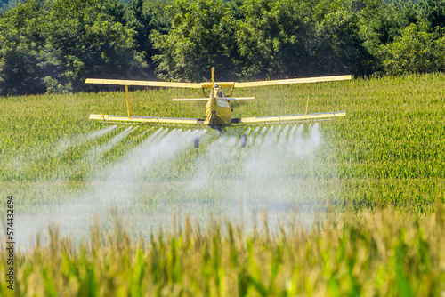 Yellow Crop Duster Spraying Pestisides On Crops photo