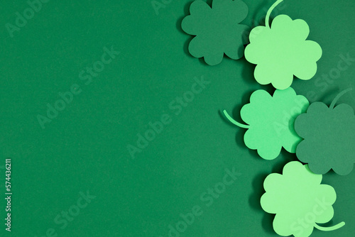 Patrick's Day composition. Holiday decoration for St. Patricks day, clover leaf on green background. Flat lay, top view, copy space 