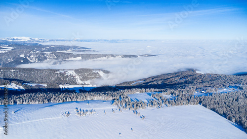 Beautiful winter scenery seen from the air with blue sky and powder snow © Photofex