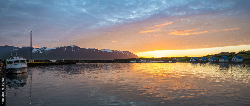 Summer sunset in at the coast of the village on island of Hrisey in Iceland