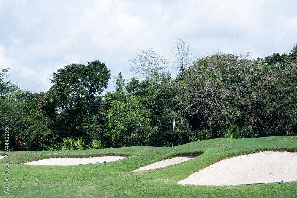 Three sand traps of a golf course protecting the green with a flag, Mexico