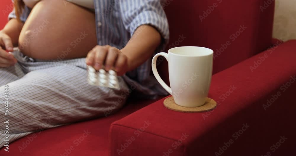 Pregnant woman drinking daily vitamins for healthcare Pregnant woman drinking daily vitamins for healthcare