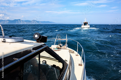 The boat is towing another in the Pacific Ocean, Kamchatka, sailing in the sea, ships. Kamchatka.