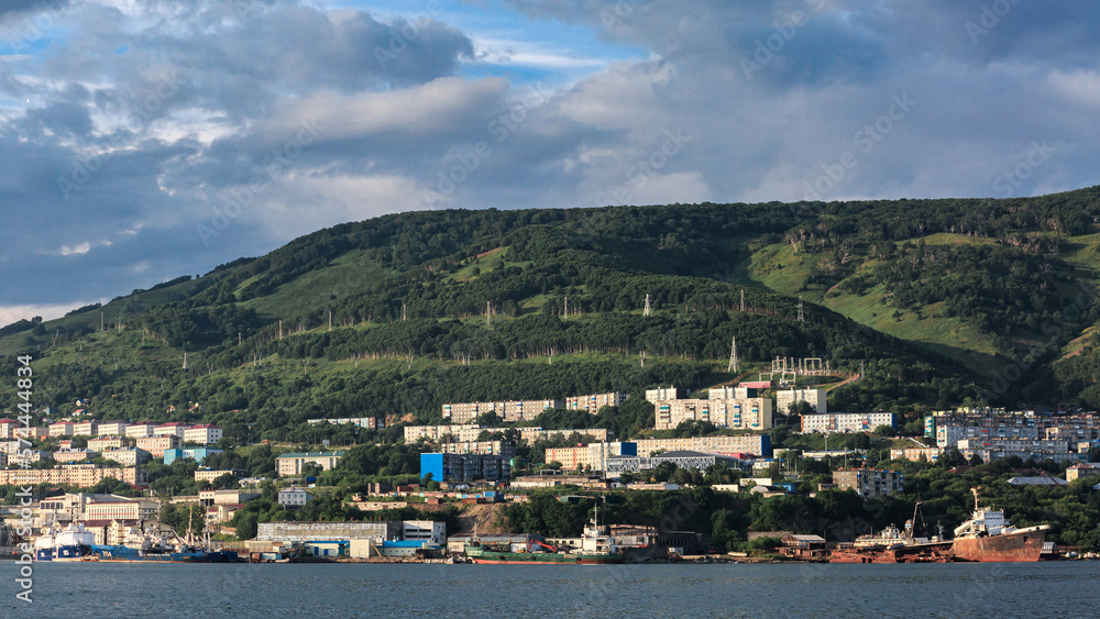 The Pacific Ocean, ships, mountains, many houses on the mountain, clear sunny weather, Kamchatka.