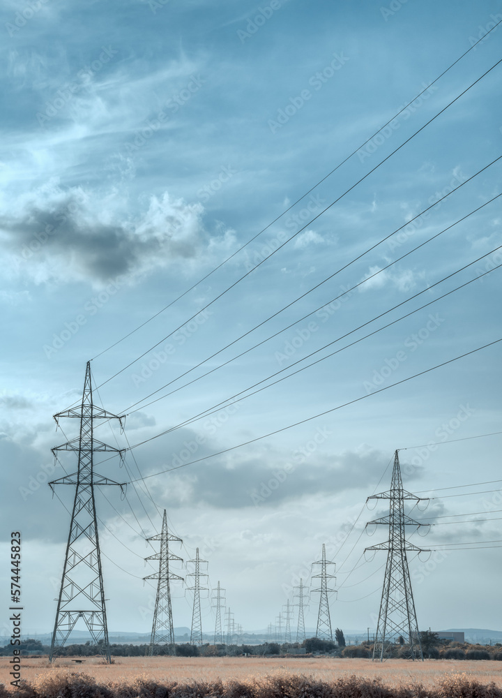 High voltage electricity towers under the sky. with cinematic look, in vertical 
