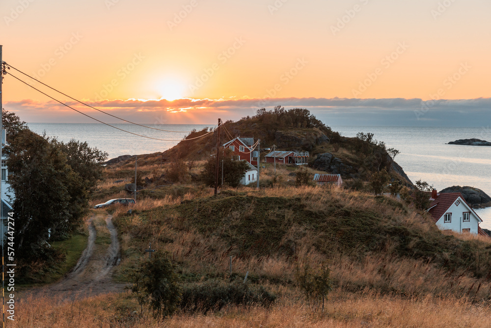Sunset in Norway with little house and powerline