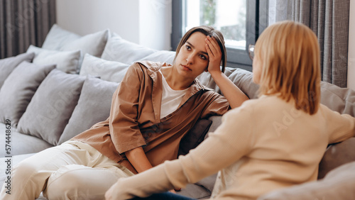 A young woman in a consultation with a professional psychologist listens to advice on improving behavior in life. The modern millennial woman is developing mindfulness and psychological health