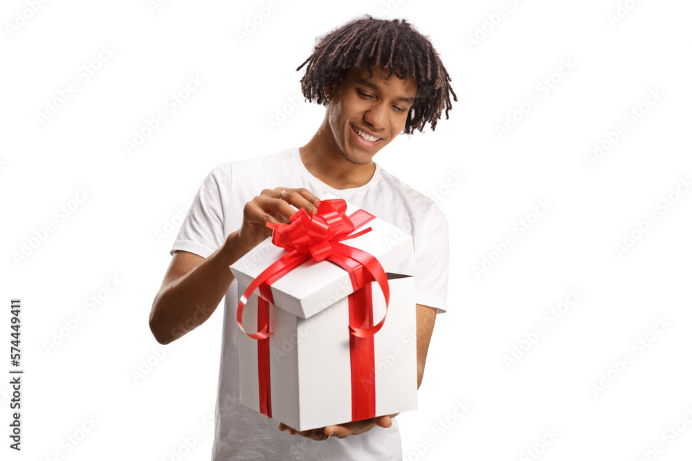 Happy young african american guy opening a gift box with red ribbon Happy young african american guy opening a gift box with red ribbon