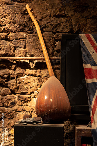 A musical instrument, one of the symbols of eastern and western civilization, and the flag of England on the wall , concept of abandoned space , book cover idea