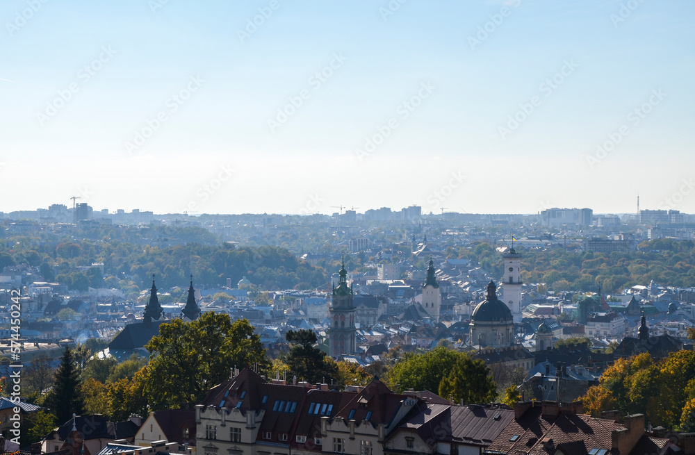Panoramic view of old historical city center with churches, town hall and houses roofs at sunny autumn day. Lviv, Ukraine