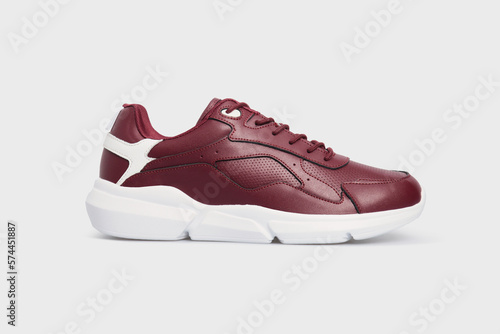 Classic fashion leather women's burgundy sneakers shoe for fitness gym running jogging isolated on white background. Template, mock up