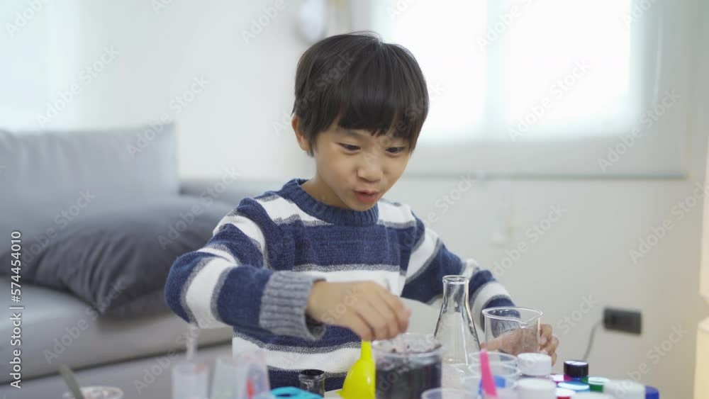 An Asian student kid study, learn on test tube in lab or laboratory in school, medical, chemistry. Experiment science. Education in classroom. People lifestyle An Asian student kid study, learn on test tube in lab or laboratory in school, medical, chemistry. Experiment science. Education in classroom. People lifestyle
