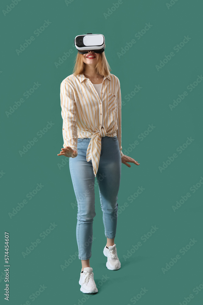 Pretty young woman in VR glasses on green background Pretty young woman in VR glasses on green background