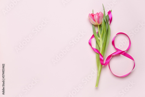 Fototapeta Naklejka Na Ścianę i Meble -  Beautiful tulip flower and figure 8 made of ribbon on color background. Women's Day celebration