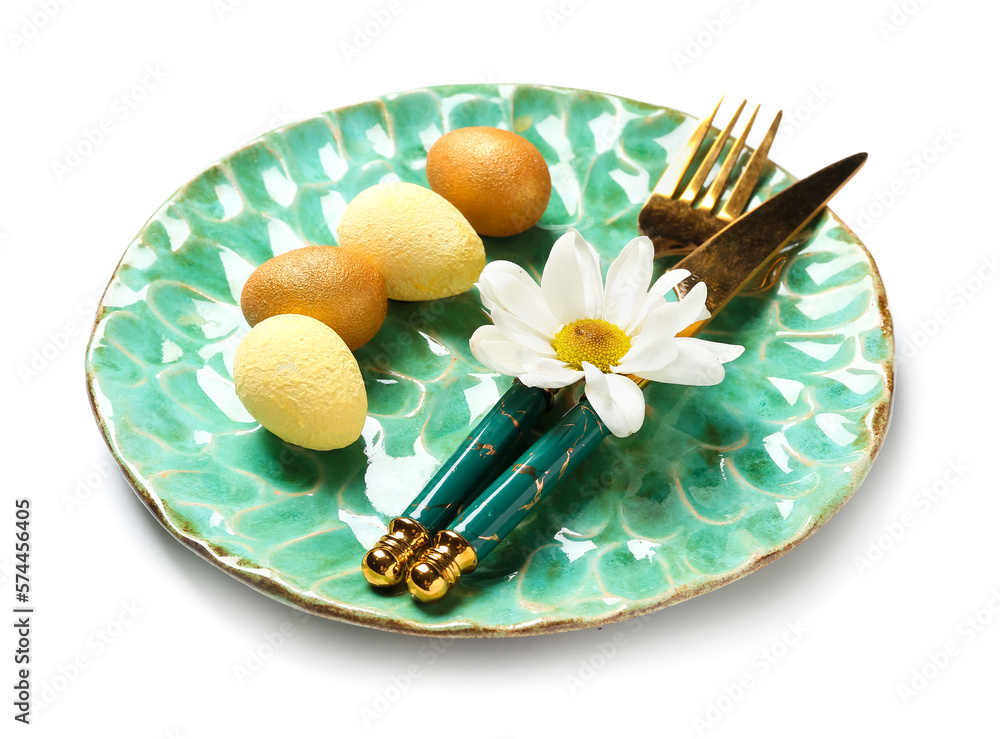 Beautiful table setting with Easter eggs and chamomile flower on white background Beautiful table setting with Easter eggs and chamomile flower on white background