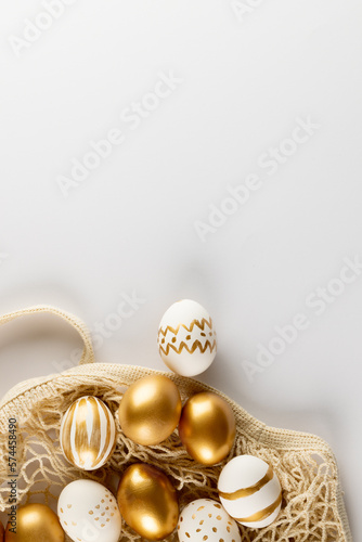 Image of multi coloured easter eggs and copy space on white background