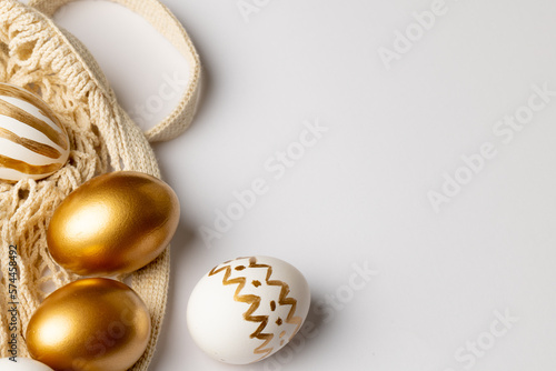 Image of multi coloured easter eggs and copy space on white background