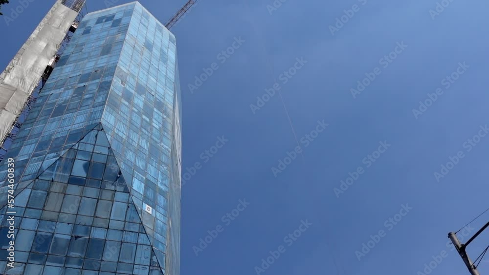 Skycraper city high rise glass building construction site with crane