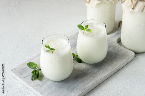 Glass cup of Turkish traditional drink ayran , kefir or buttermilk made from yogurt, healthy food photo