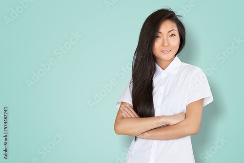 Smiling young woman posing with hands crossed