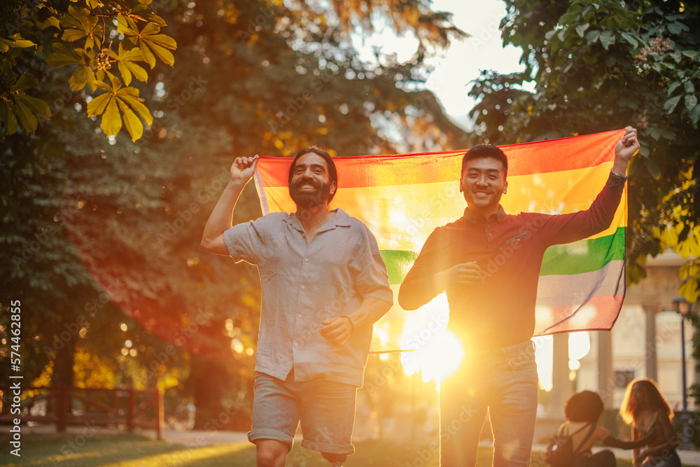 Fototapeta premium Bisexual couple walking with pride flag