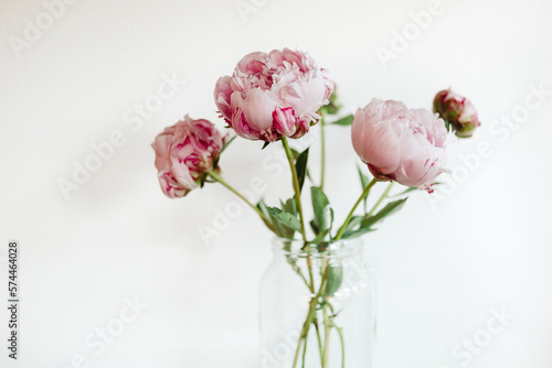 Fototapeta Naklejka Na Ścianę i Meble -  Pink peonies in a glass vase