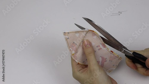 Hobby sewing on a sewing machine. The tailor cuts out the details of the product and sews. The girl is engaged in needlework, creativity.