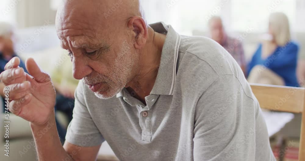Sad senior biracial man crying at support group meeting of diverse seniors, copy space, slow motion Sad senior biracial man crying at support group meeting of diverse seniors, copy space, slow motion