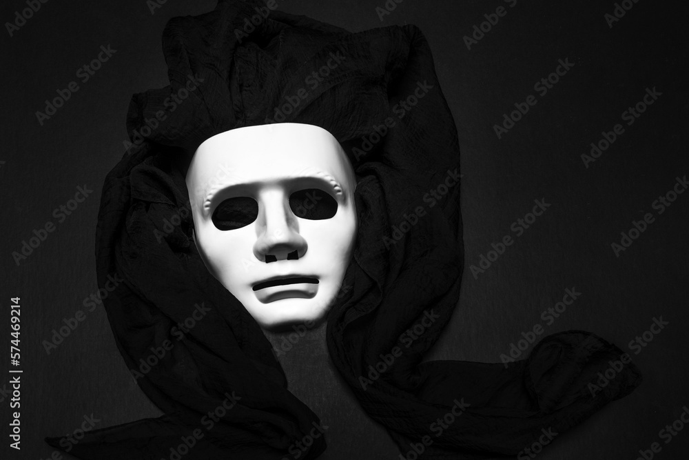 White masks playing dress up for the masquerade ball with a black cloth
