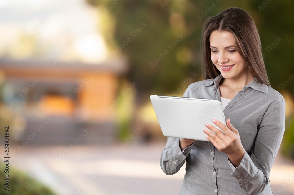 Fototapeta premium Cheerful young person using a digital tablet