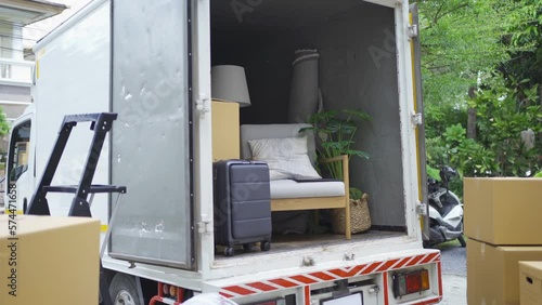 Truck car moving house for customers, delivering boxes and furniture. Vehicle transportation. Shipping and packaging business occupation service company. People lifestyle.