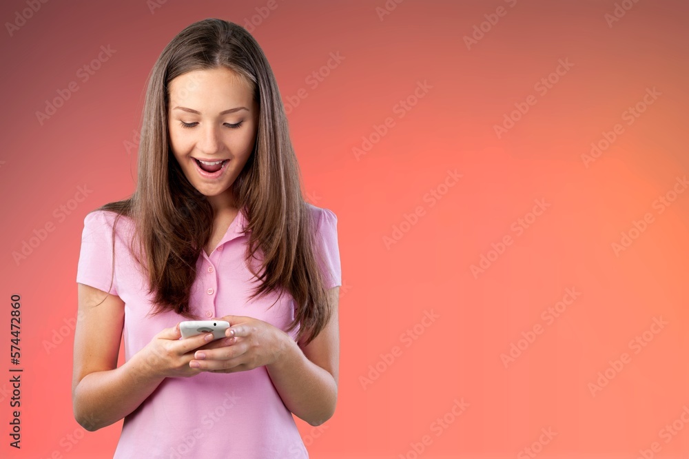 Cheerful young person using a phone Cheerful young person using a phone