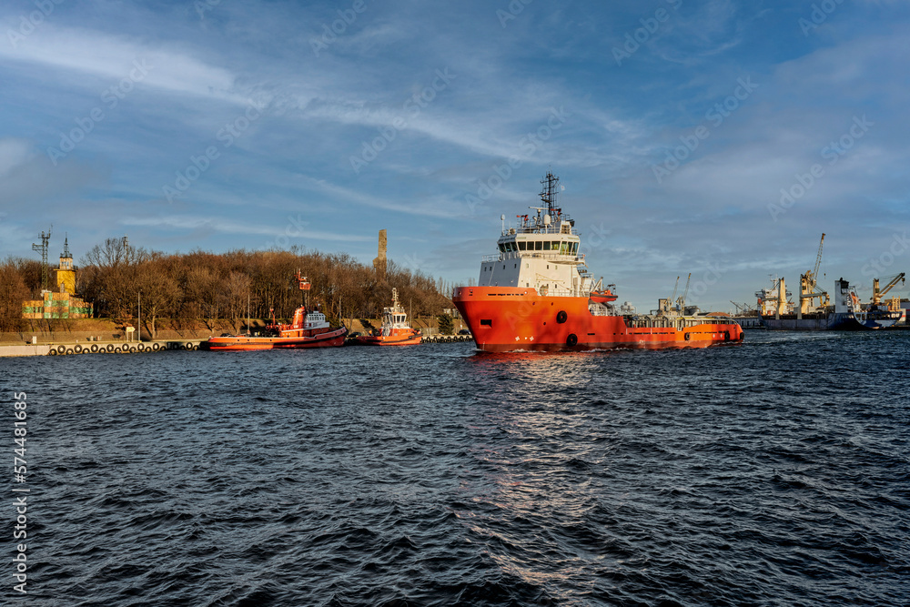 Port of Gdansk, Baltic Sea, the tug shown in the picture is a multi-purpose offshore vessel - a supply ship, an ocean tug and an anchor handling unit. The ship is 69 meters long, its total tonnage is 