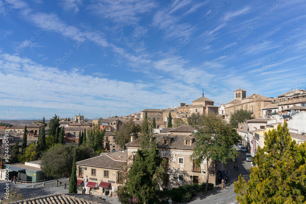 Panoramic view of one of the parts of the city of Toledo where we can find very nice stone houses on a summer day with partly clear sky. Spain