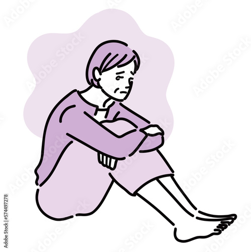 抑うつで涙を流して膝を抱えて悩んでいる女性
