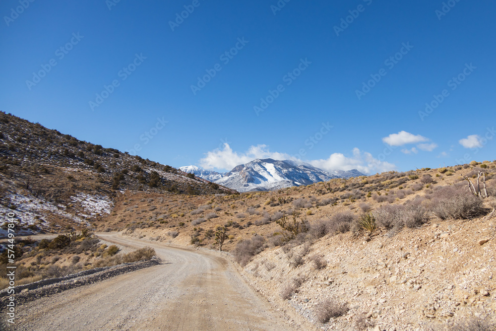 Dirt road and snow covered mountains at Spring Mountain National Recreation Area, Nevada Dirt road and snow covered mountains at Spring Mountain National Recreation Area, Nevada