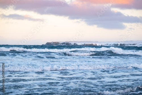 Fototapeta Naklejka Na Ścianę i Meble -  Pure blue ocean water at sunset, Ocean coastline with mountains, Winter landscape with snow, clouds and stormy sea