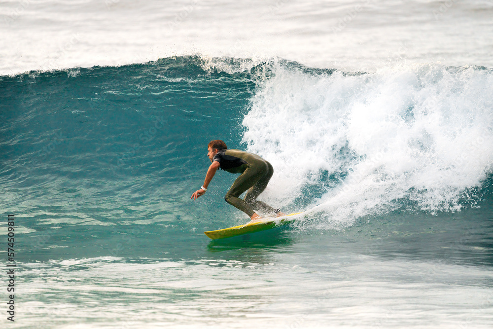 Professional surfer riding ocean waves On banzai pipeline north shore Oahu Hawaii. Surfing a large sea wave on short surfboard in the summer sun. Professional surfer riding ocean waves On banzai pipeline north shore Oahu Hawaii. Surfing a large sea wave on short surfboard in the summer sun.