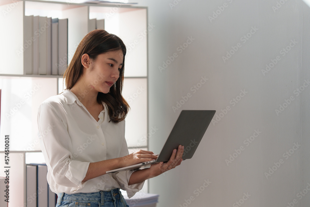 Beautiful business woman using laptop to analyze fund investment. Business Consulting, Accounting, finance investment concept. Beautiful business woman using laptop to analyze fund investment. Business Consulting, Accounting, finance investment concept.