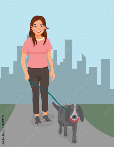 Young woman walking dog in the park