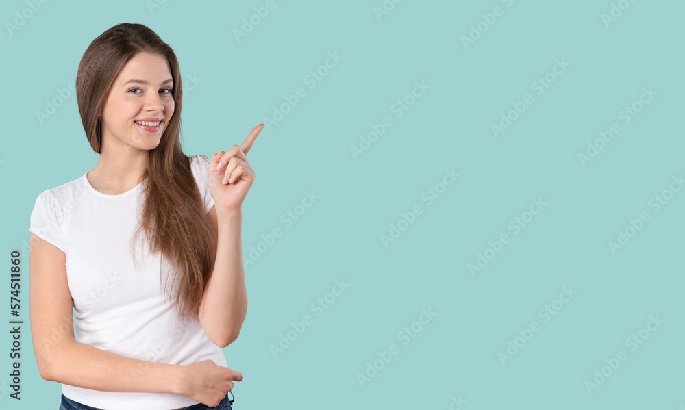 Portrait of happy young woman pointing finger Portrait of happy young woman pointing finger